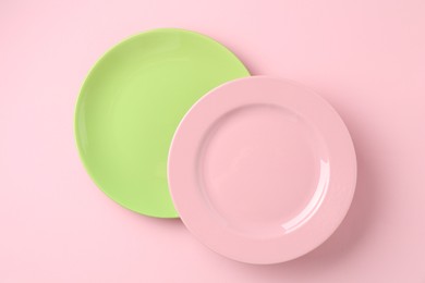 Photo of Stylish plates on pink background, top view