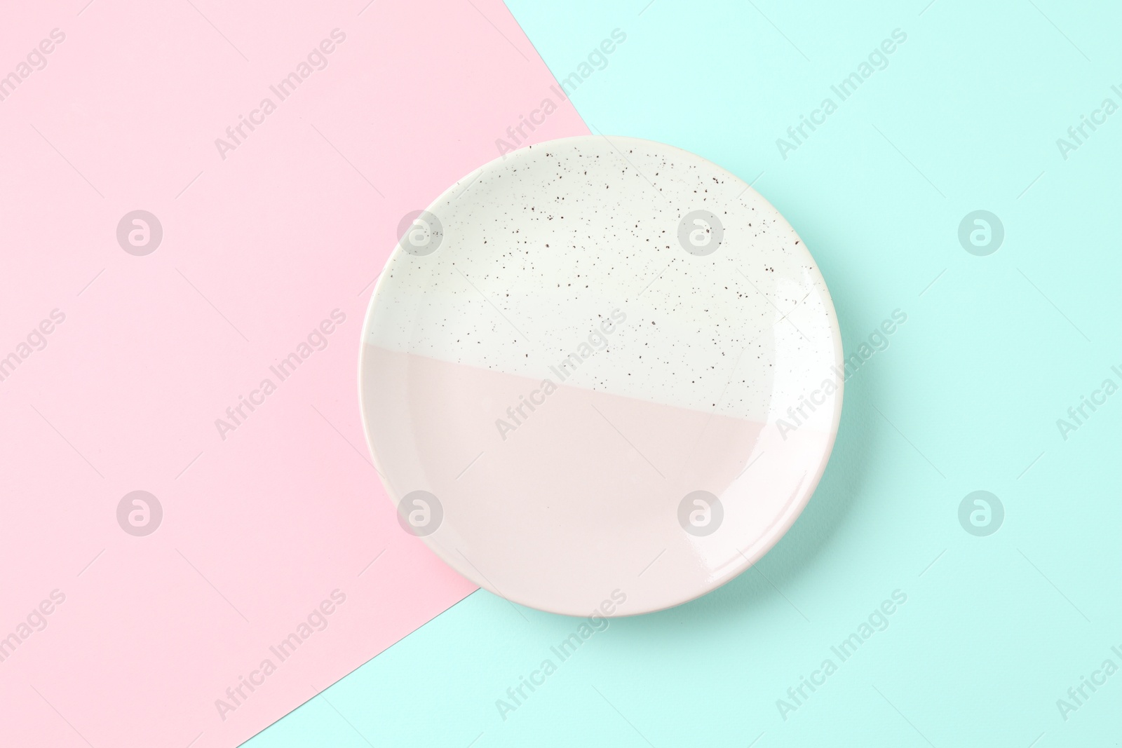 Stylish plate on color background, top view Photo of Stylish plate on color background, top view