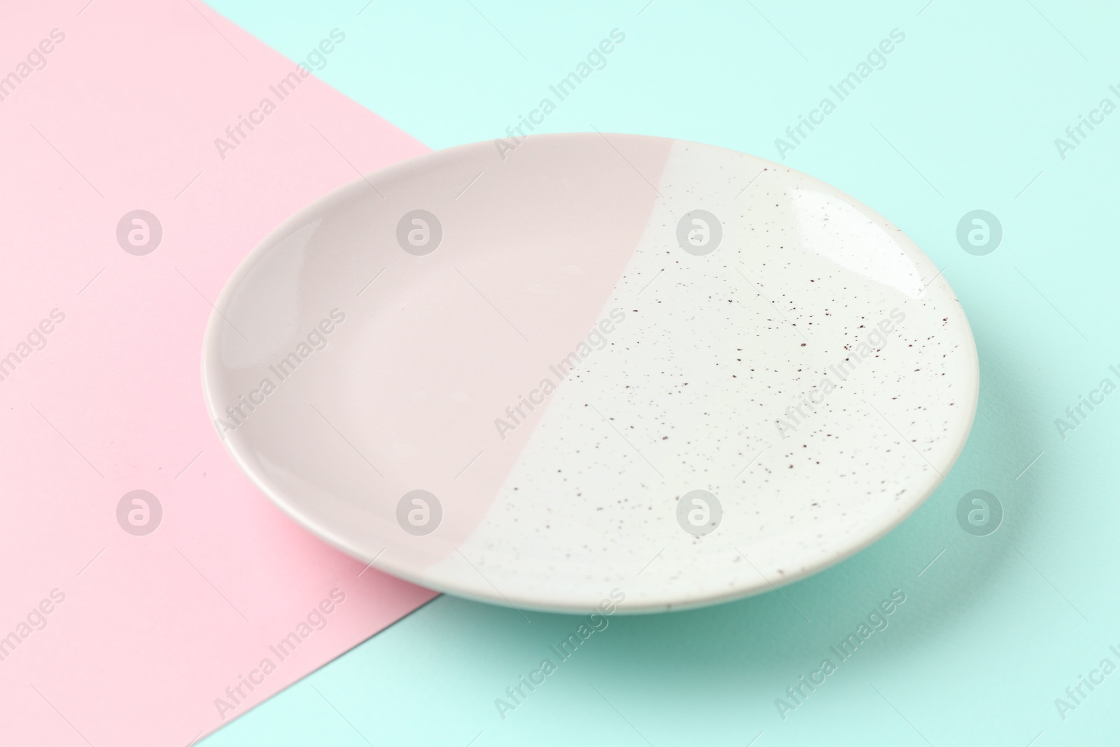 One stylish plate on color background, closeup Photo of One stylish plate on color background, closeup