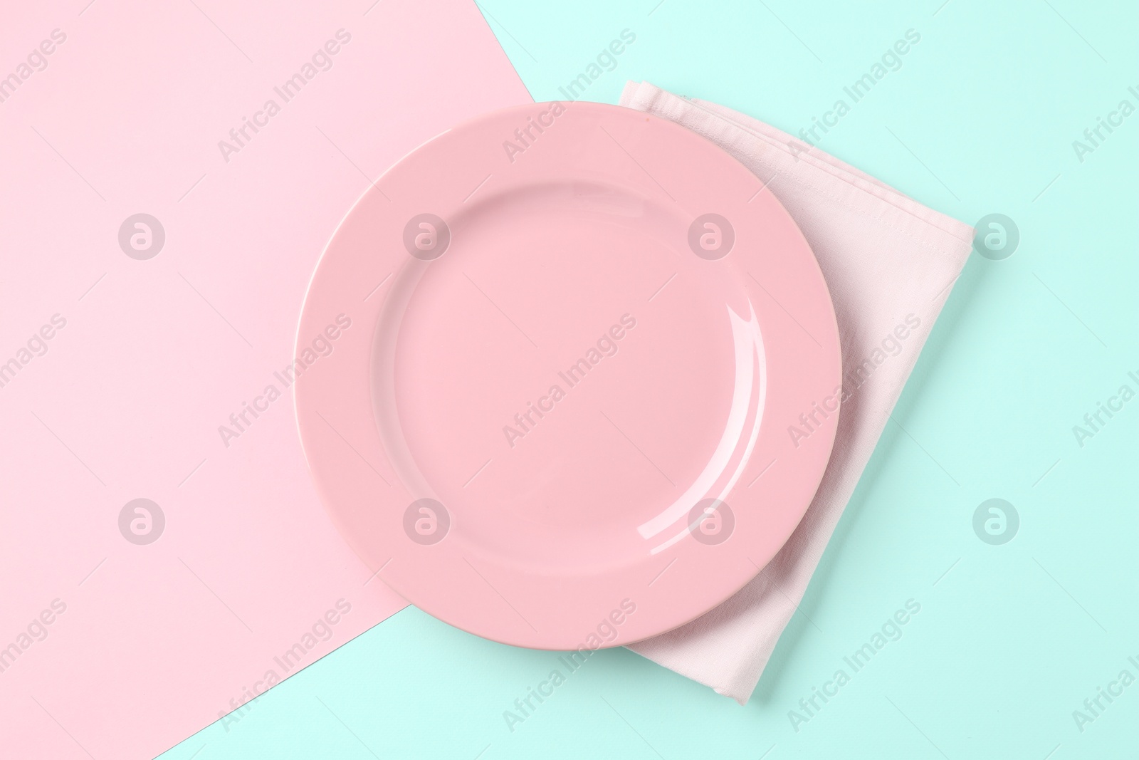 Stylish plate and napkin on color background, top view Photo of Stylish plate and napkin on color background, top view
