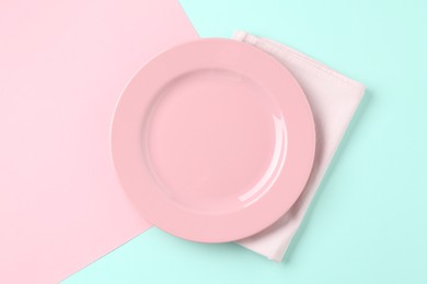 Photo of Stylish plate and napkin on color background, top view