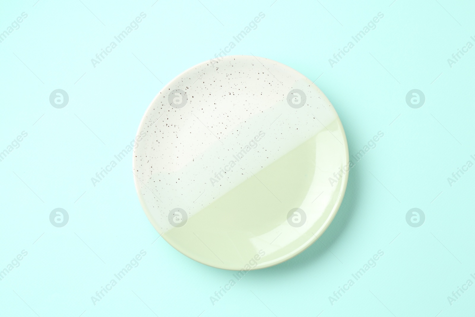 Stylish plate on light blue background, top view Photo of Stylish plate on light blue background, top view