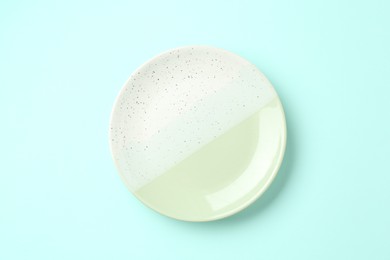 Photo of Stylish plate on light blue background, top view