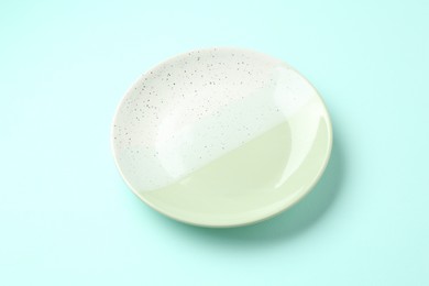 Photo of Stylish plate on light blue background, above view