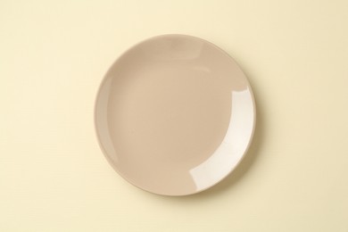 Photo of Stylish plate on beige background, top view