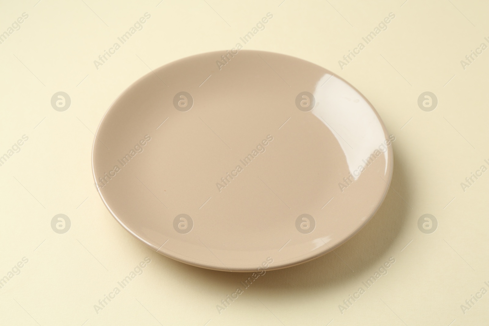 One stylish plate on beige background, closeup Photo of One stylish plate on beige background, closeup