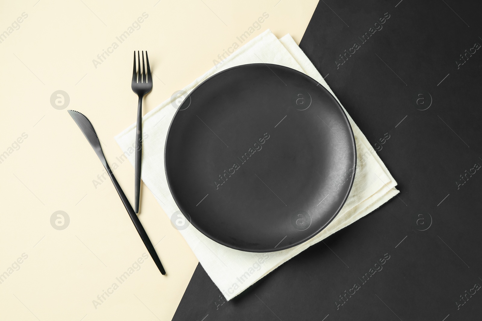 Stylish plate, cutlery and napkin on color background, flat lay Photo of Stylish plate, cutlery and napkin on color background, flat lay