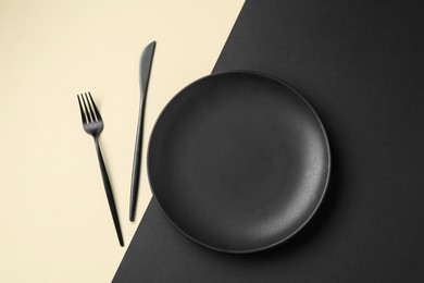 Photo of Stylish plate and cutlery on color background, flat lay