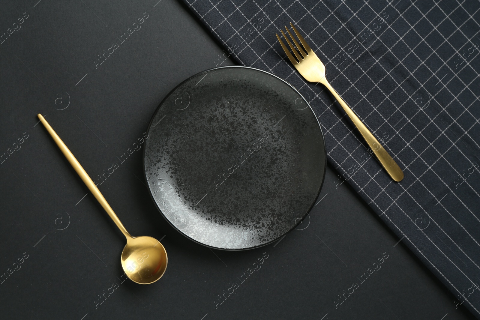 Stylish plate, cutlery and runner on black background, flat lay Photo of Stylish plate, cutlery and runner on black background, flat lay