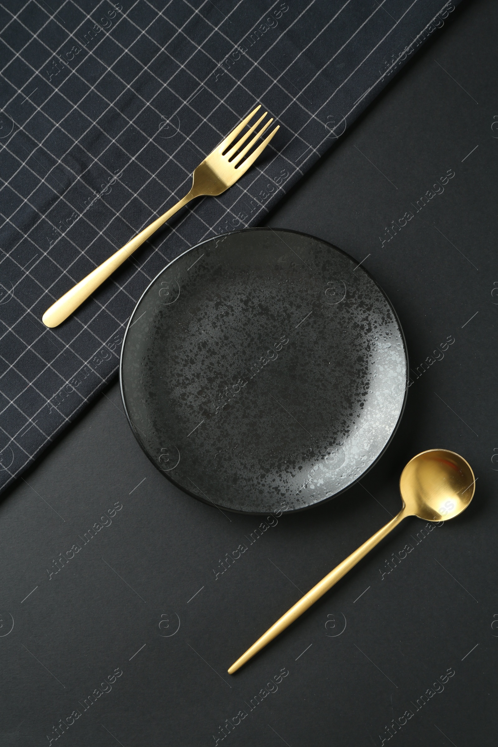 Photo of Stylish plate, cutlery and runner on black background, flat lay