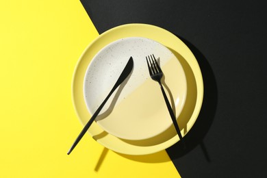 Photo of Stylish plates and cutlery on color background, top view