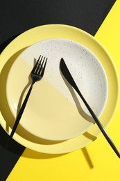 Photo of Stylish plates and cutlery on color background, top view
