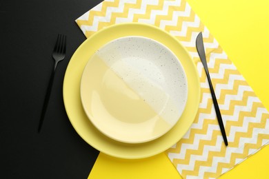 Photo of Stylish plates, cutlery and napkin on color background, flat lay