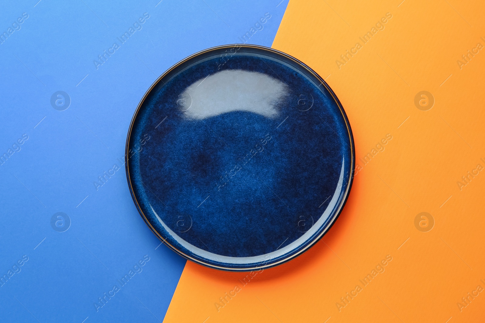 One stylish plate on color background, top view Photo of One stylish plate on color background, top view