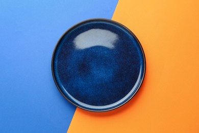 Photo of One stylish plate on color background, top view