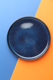 Photo of One stylish plate on color background, top view