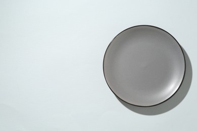 Photo of One stylish plate on white background, top view. Space for text