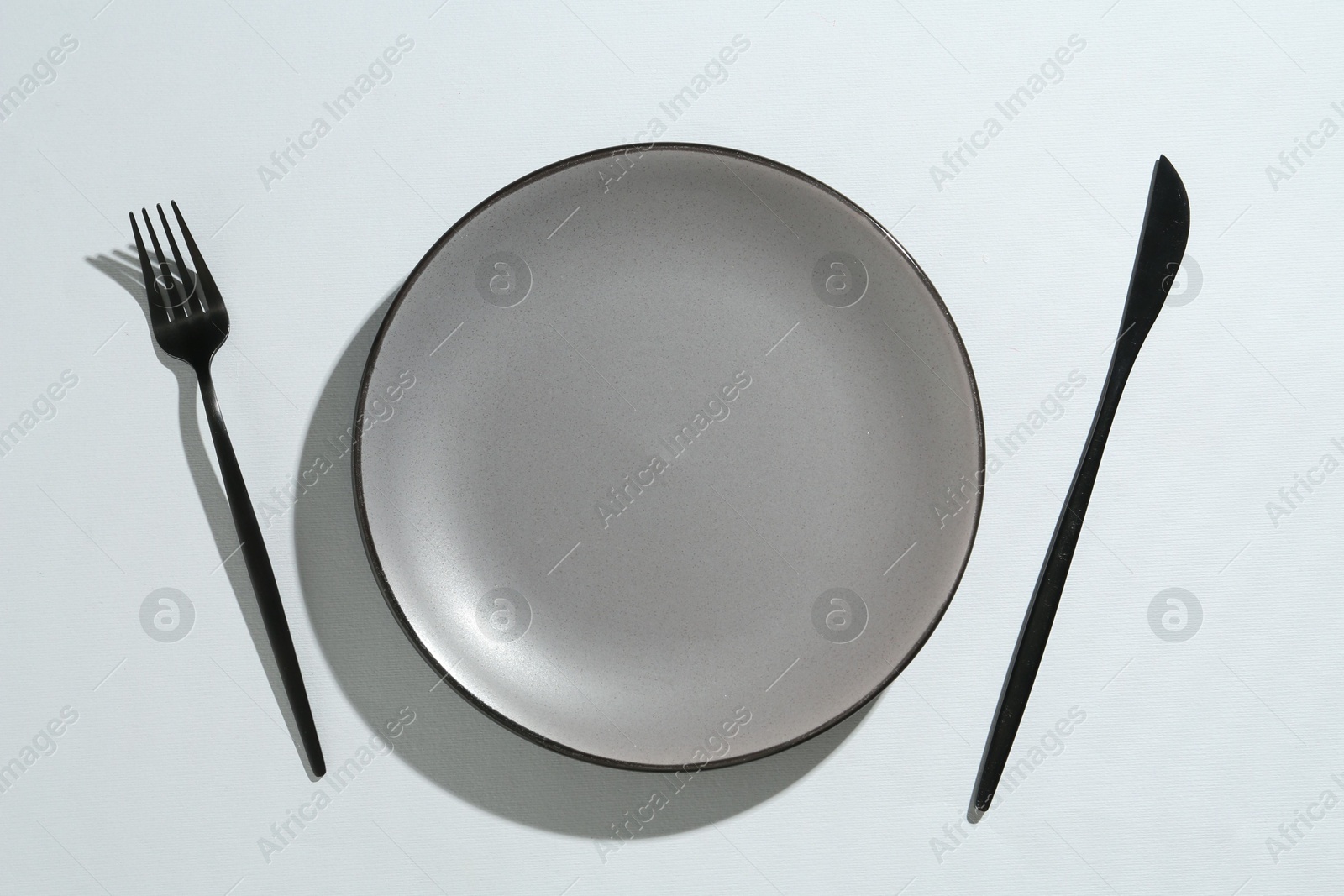Stylish plate and cutlery on white background, flat lay Photo of Stylish plate and cutlery on white background, flat lay