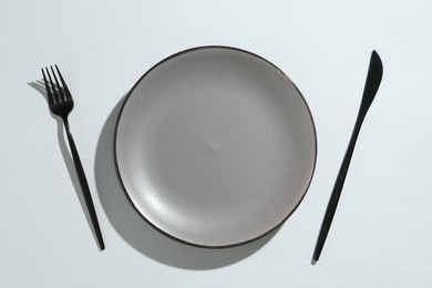 Photo of Stylish plate and cutlery on white background, flat lay