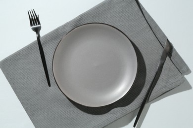 Photo of Stylish plate, cutlery and napkin on white background, flat lay