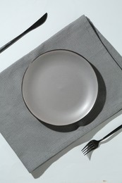Photo of Stylish plate, cutlery and napkin on white background, flat lay