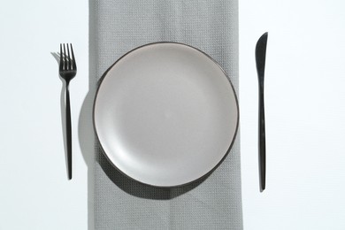 Photo of Stylish plate, cutlery and runner on white background, flat lay