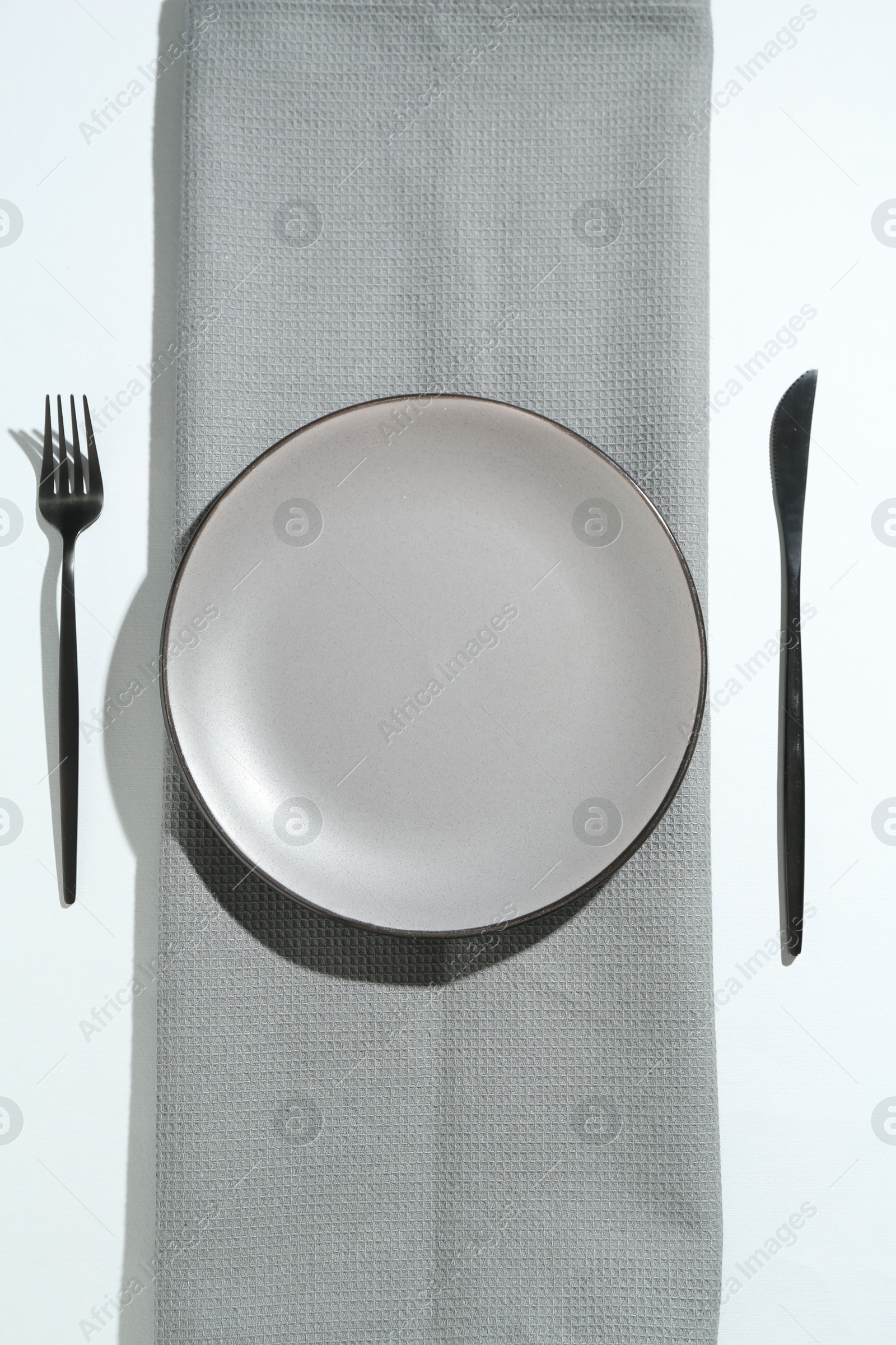 Stylish plate, cutlery and runner on white background, flat lay Photo of Stylish plate, cutlery and runner on white background, flat lay