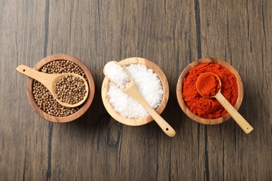 Photo of Different aromatic spices on wooden table, flat lay
