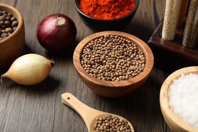 Photo of Different aromatic spices on wooden table, closeup