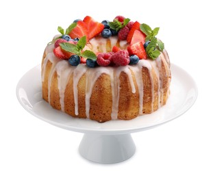 Photo of Delicious bundt cake with berries, glaze and mint isolated on white
