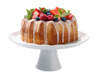 Photo of Delicious bundt cake with berries, glaze and mint isolated on white