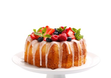 Photo of Delicious bundt cake with berries, glaze and mint isolated on white
