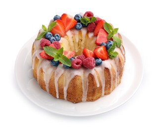 Photo of Delicious bundt cake with berries, glaze and mint isolated on white