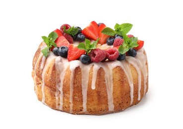 Photo of Delicious bundt cake with berries, glaze and mint isolated on white