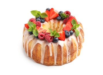 Photo of Delicious bundt cake with berries, glaze and mint isolated on white