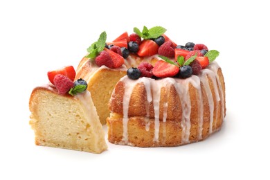 Photo of Delicious bundt cake with berries, glaze and mint isolated on white