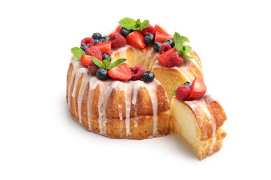 Photo of Delicious bundt cake with berries, glaze and mint isolated on white