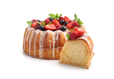 Photo of Delicious bundt cake with berries, glaze and mint isolated on white