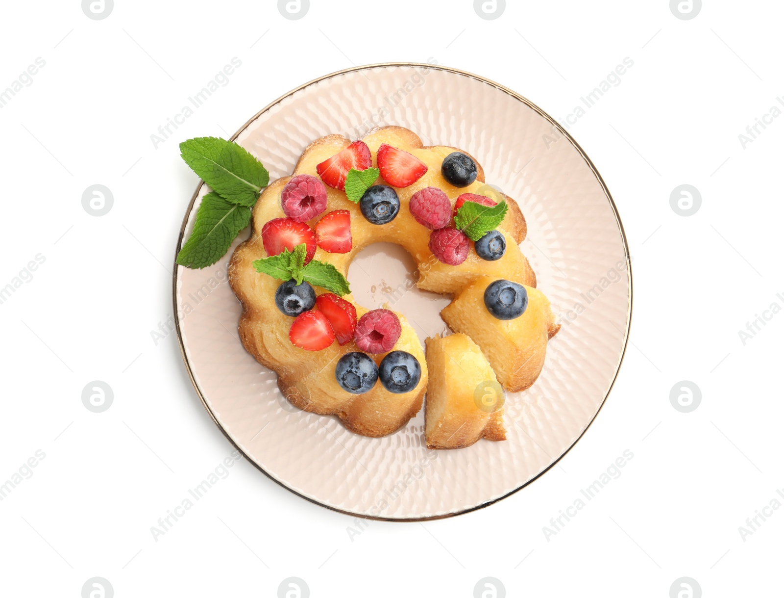 Tasty Bundt cake with berries and mint isolated on white, top view Photo of Tasty Bundt cake with berries and mint isolated on white, top view