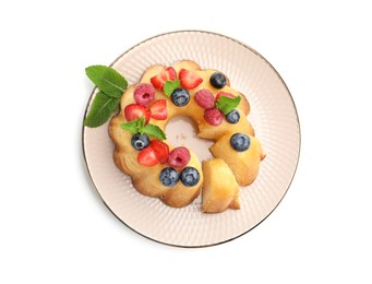Photo of Tasty Bundt cake with berries and mint isolated on white, top view