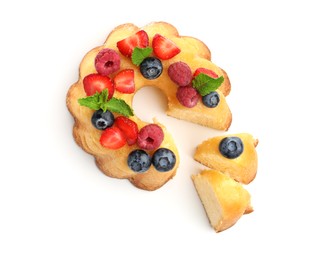 Photo of Tasty Bundt cake with berries and mint isolated on white, top view