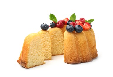 Photo of Tasty Bundt cake with berries and mint isolated on white