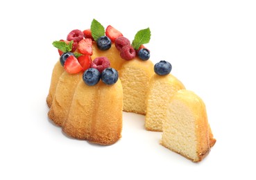Photo of Tasty Bundt cake with berries and mint isolated on white