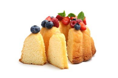Photo of Tasty Bundt cake with berries and mint isolated on white