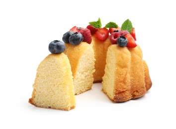 Photo of Tasty Bundt cake with berries and mint isolated on white