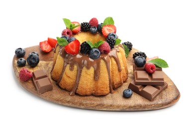 Photo of Tasty Bundt cake with berries, chocolate and mint isolated on white