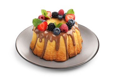 Photo of Tasty Bundt cake with berries, chocolate and mint isolated on white