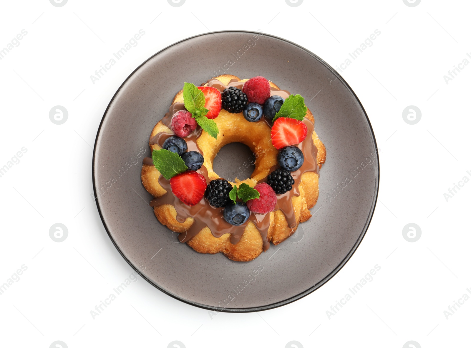 Tasty Bundt cake with berries, chocolate and mint isolated on white, top view Photo of Tasty Bundt cake with berries, chocolate and mint isolated on white, top view