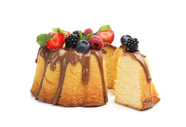 Photo of Tasty Bundt cake with berries, chocolate and mint isolated on white