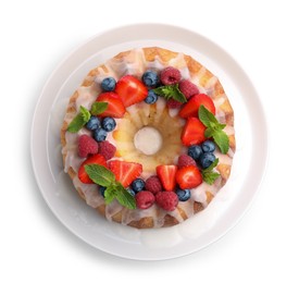 Photo of Delicious bundt cake with berries, glaze and mint isolated on white, top view